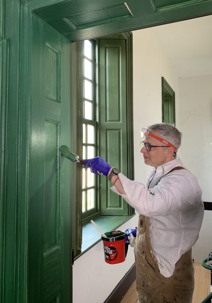 Preservationist Painting Passageway Panels at Stratford Hall